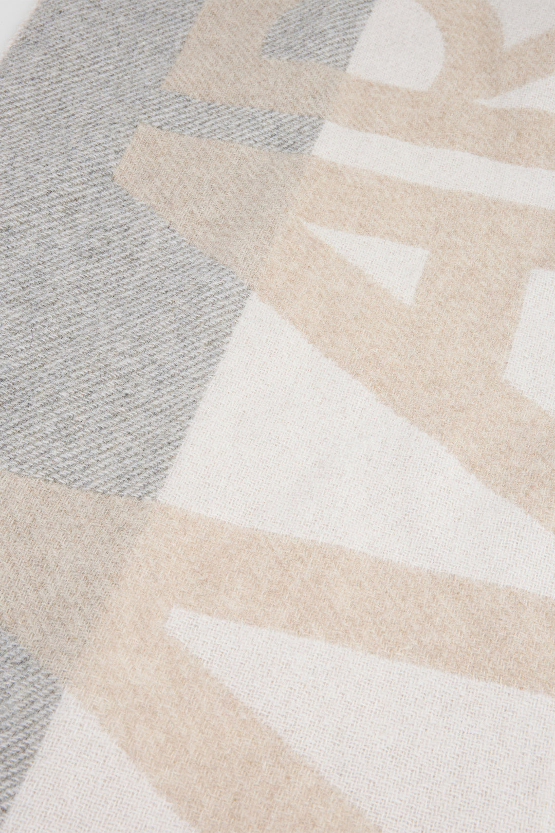 Close-up of a textured rug with geometric pattern in neutral colors.