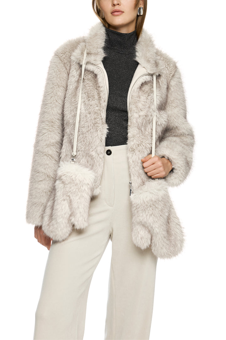 Person wearing a fluffy gray coat with a white background