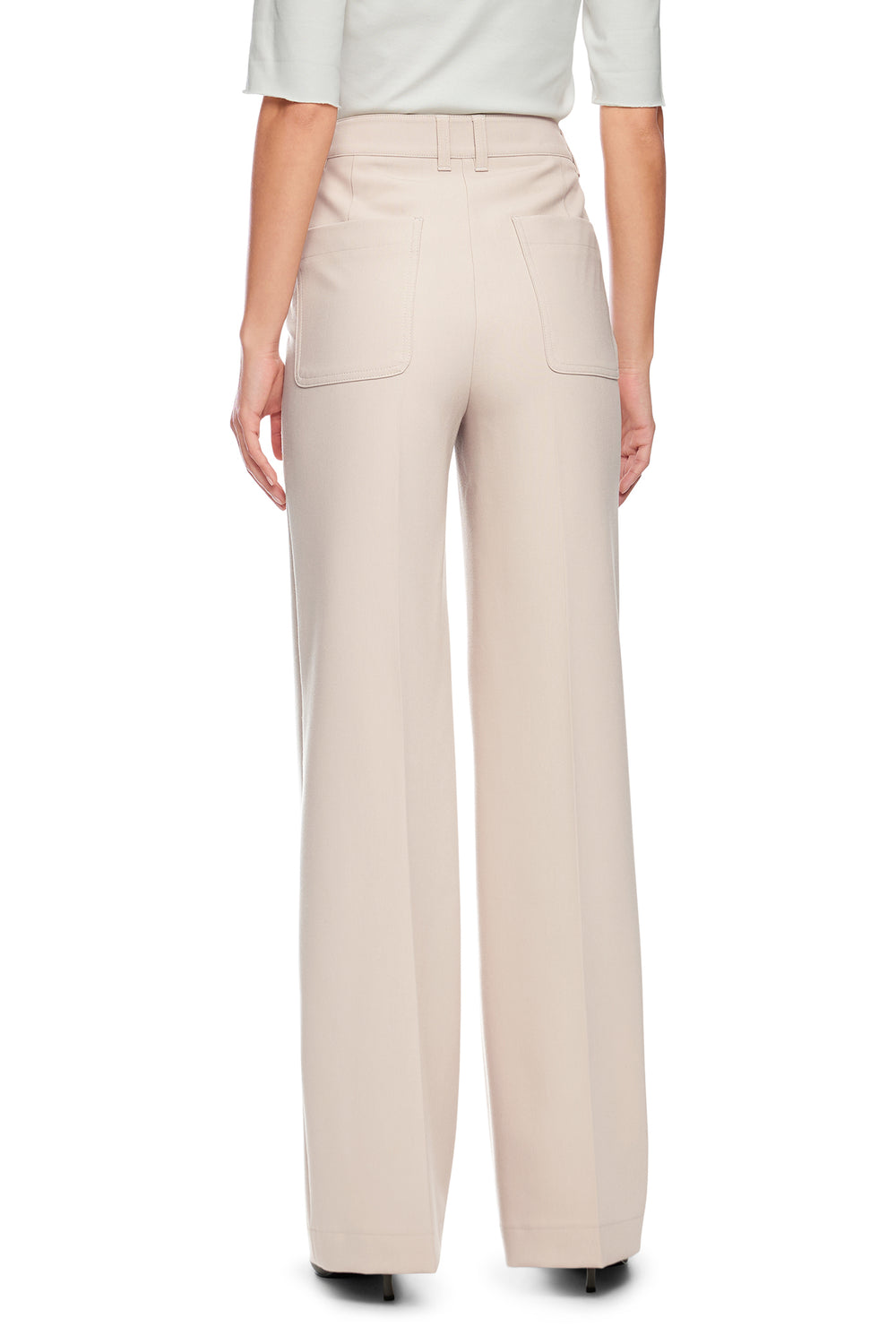 Beige pants worn by a person on a white background