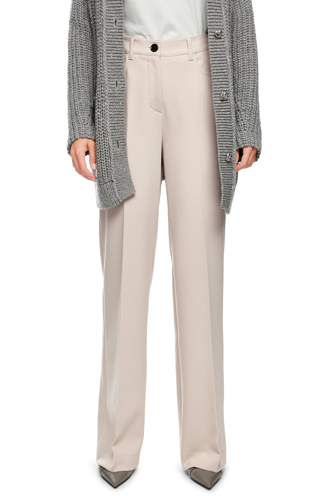 Person wearing beige pants with a gray cardigan on a white background