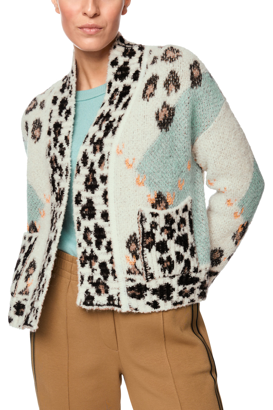 Person wearing a patterned cardigan with a white background