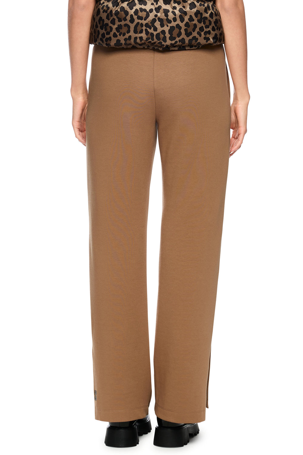 Tan pants worn by a person on a white background