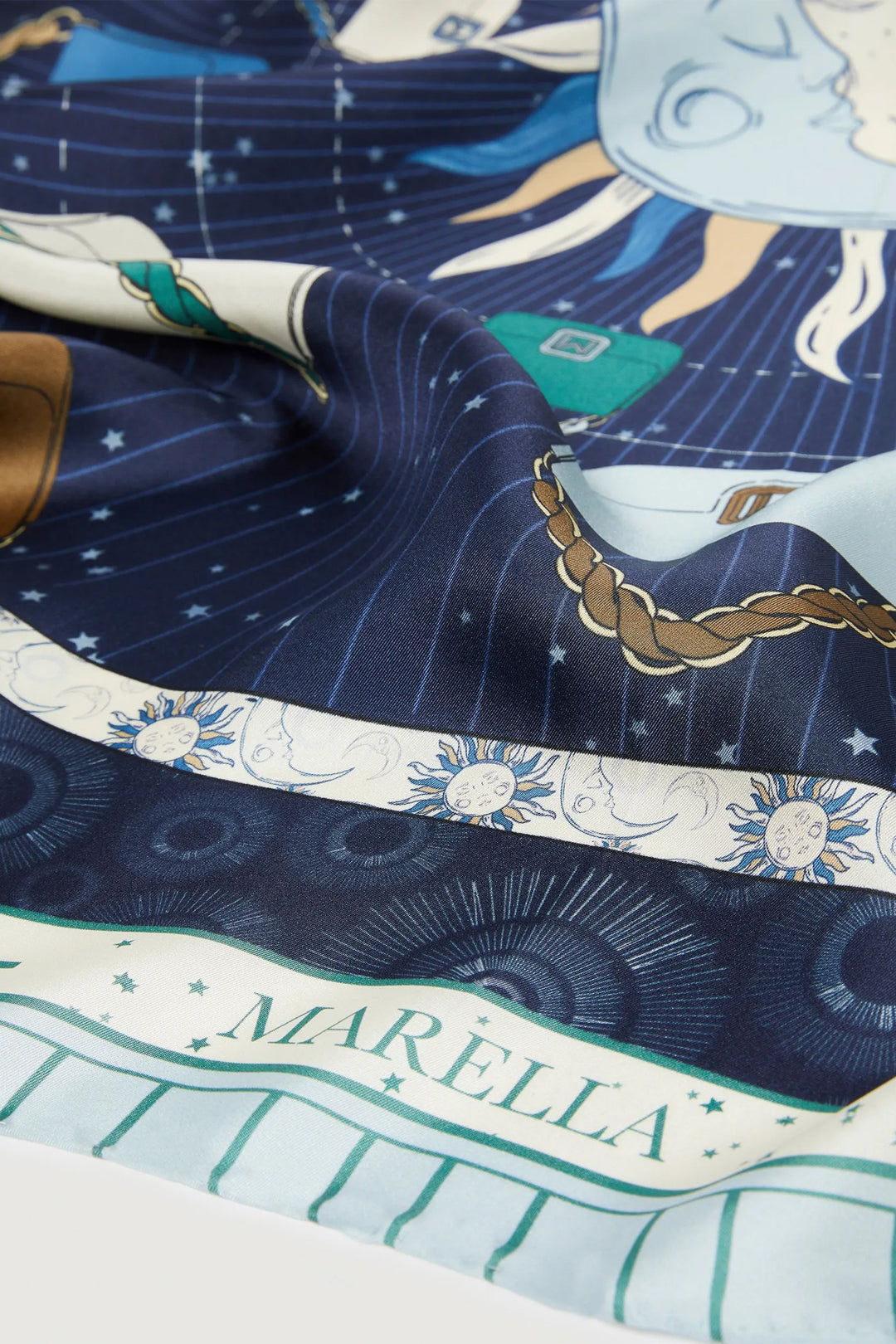 Close-up of a MARELLA scarf with celestial design and brand name.