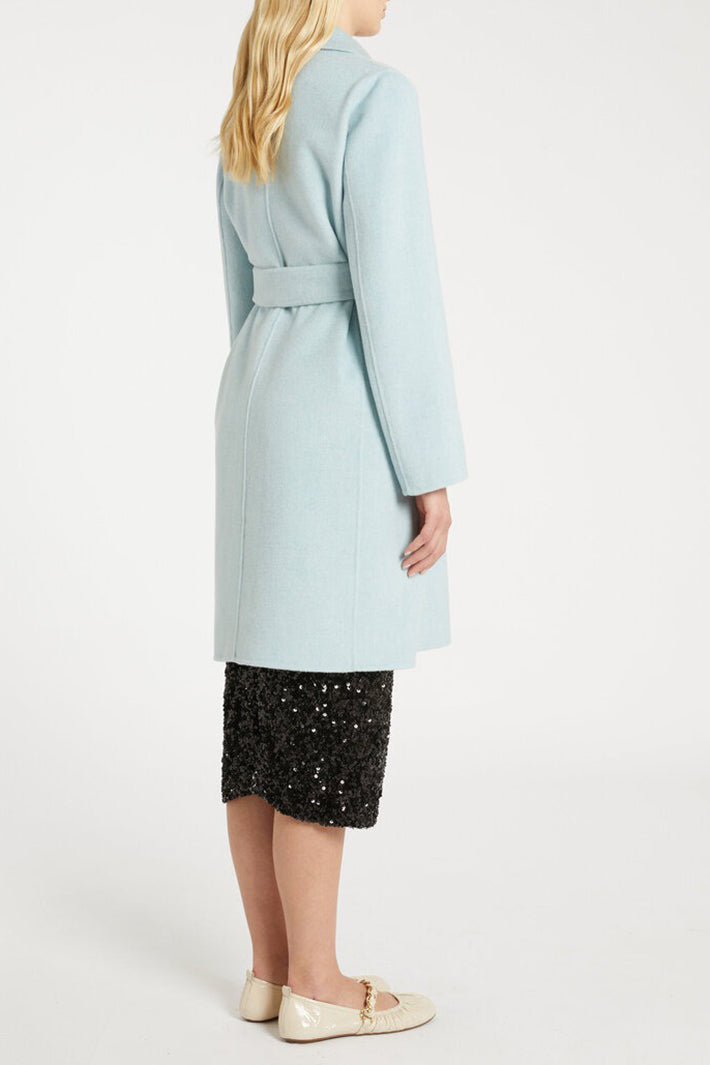 Light blue coat worn by a person on a white background
