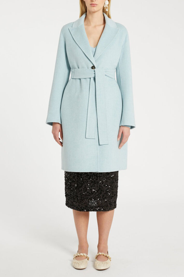 Light blue coat worn by a person on a white background