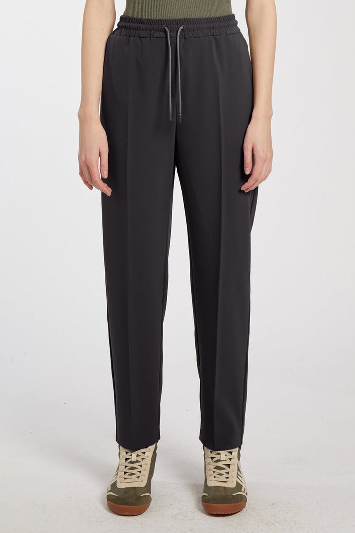 Person wearing black pants on a white background