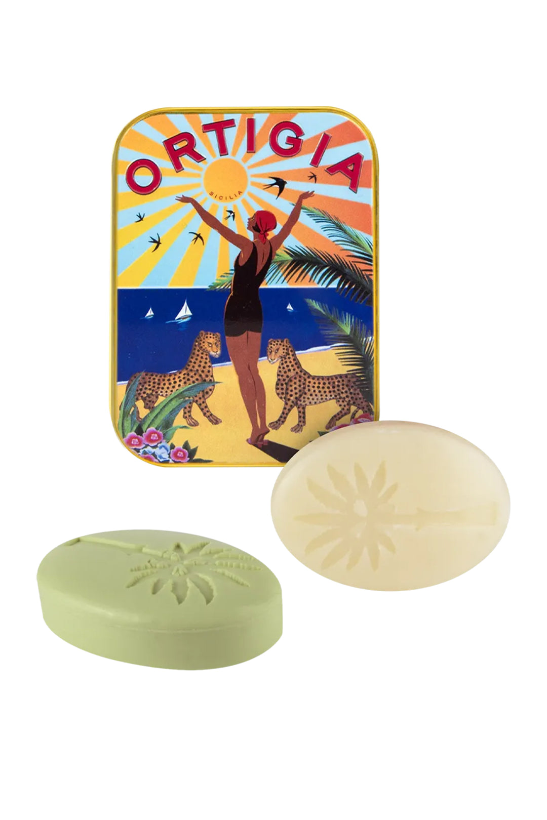 Two bars of soap in front of a colorful Ortigia tin on a white background