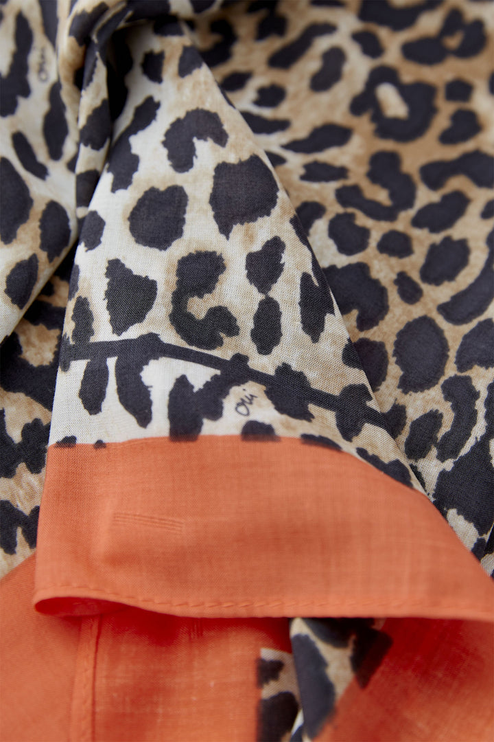Close-up of a garment with leopard print and orange trim
