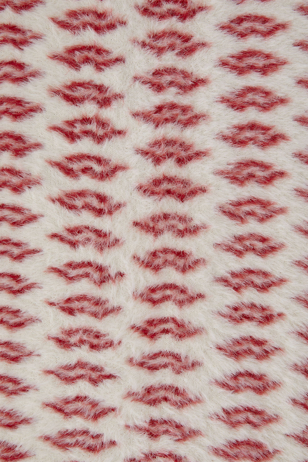 Close-up of a textured fabric with a red and white pattern