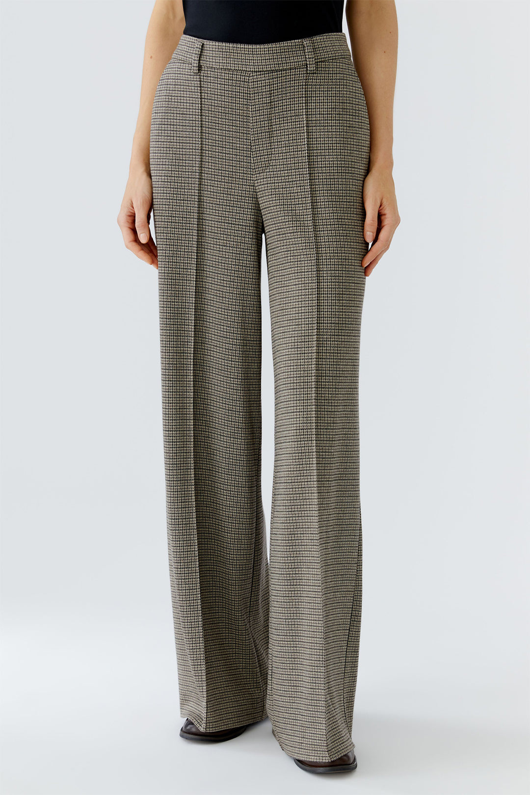 Person wearing plaid pants on a white background