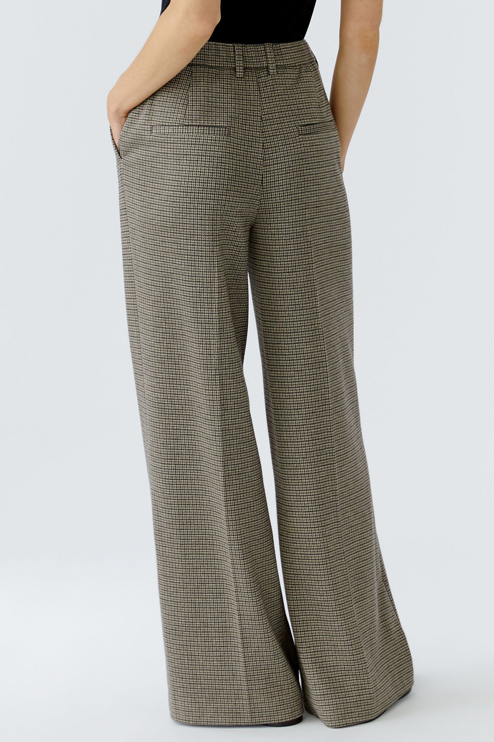 Plaid pants worn by a person on a white background