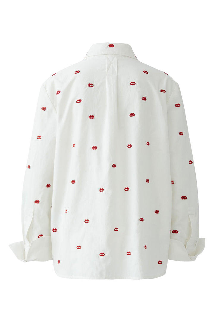 White blouse with red lip print on a white background