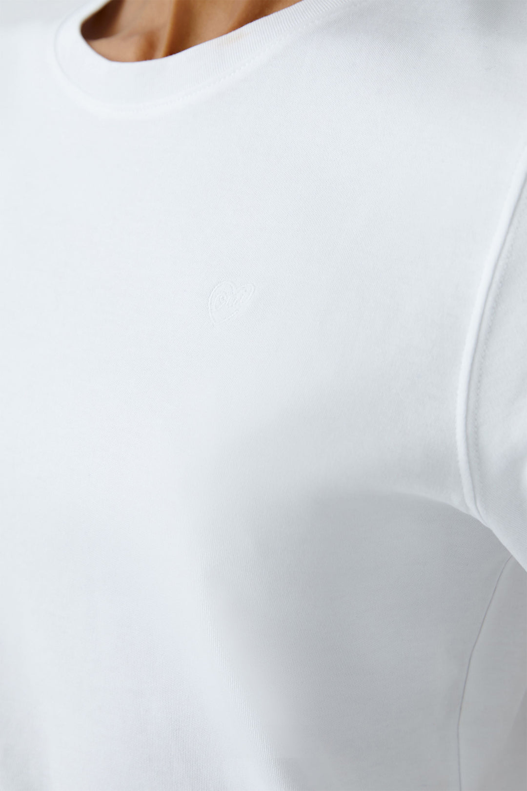 Close-up of a white dress with a fitted bodice and flowing skirt.