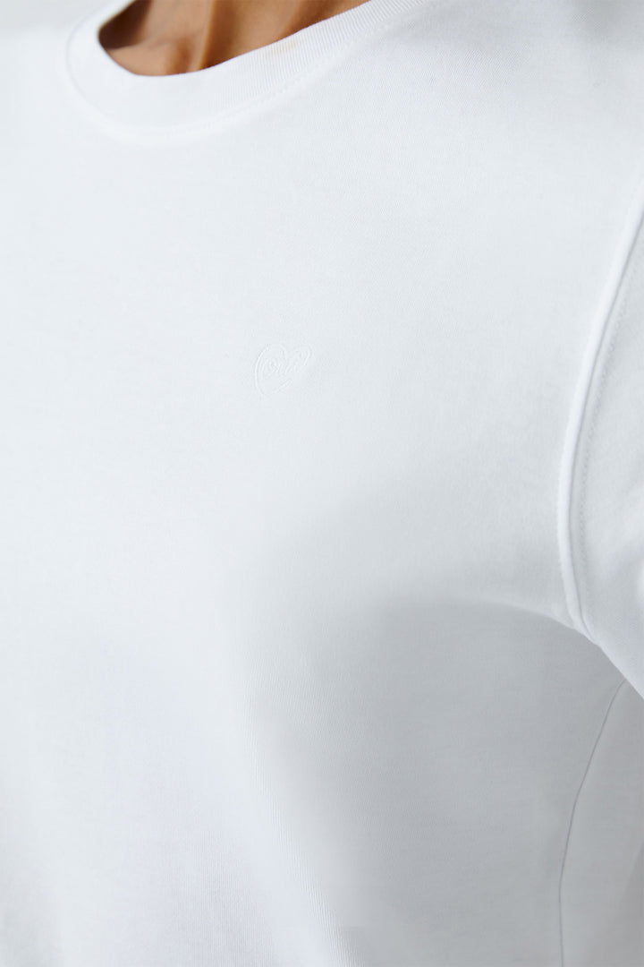 Close-up of a white dress with a fitted bodice and flowing skirt.