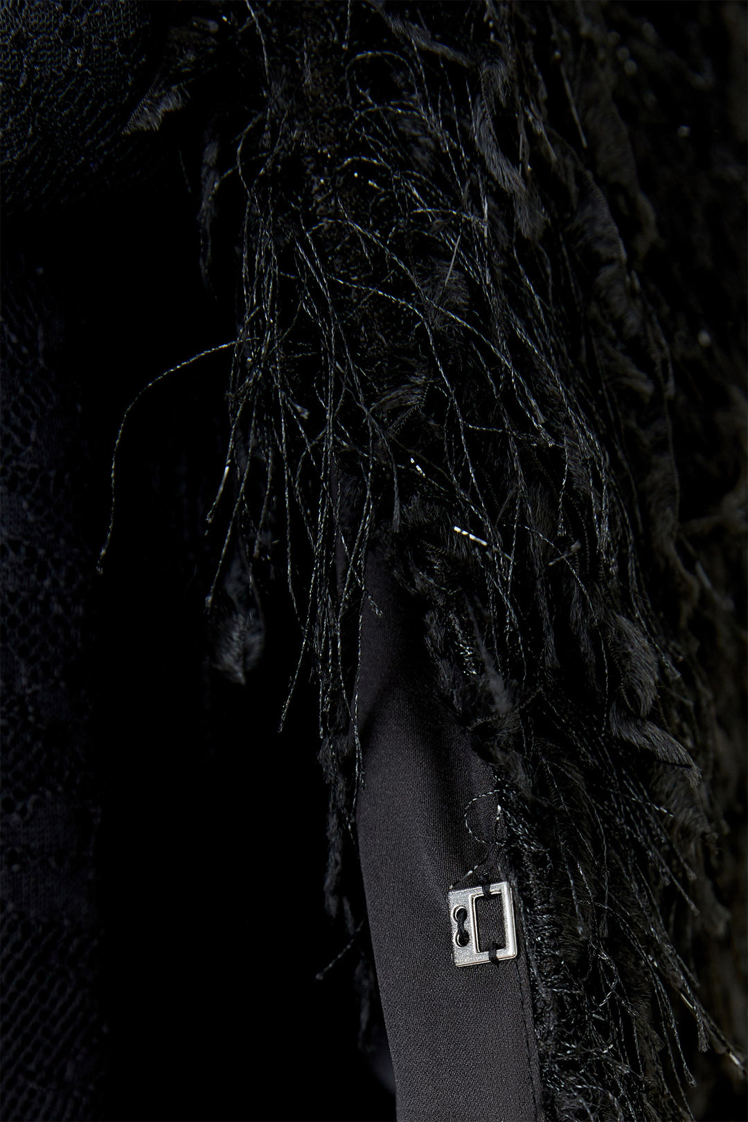 Close-up of a textured black surface with a strap and buckle.