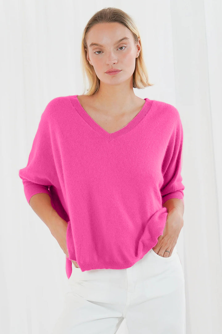 Twns The Label Jefferson bubblegum pink short sleeve V-neck oversized jumper worn with white jeans at Olivia Grace Fashion