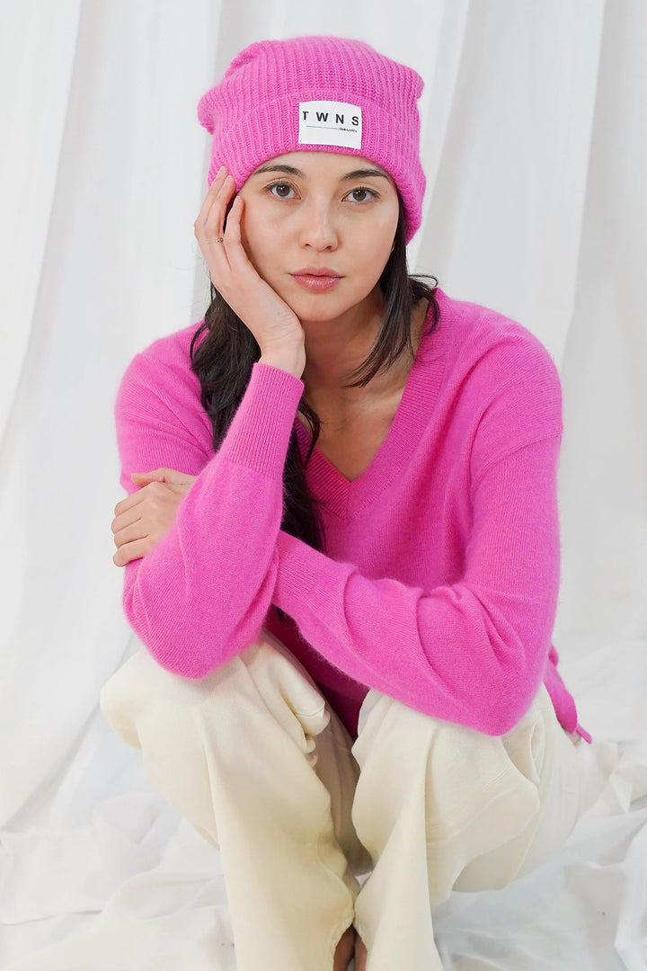 Twns The Label Littleton bubblegum pink beanie hat styled with a pink jumper and cream trousers at Olivia Grace Fashion