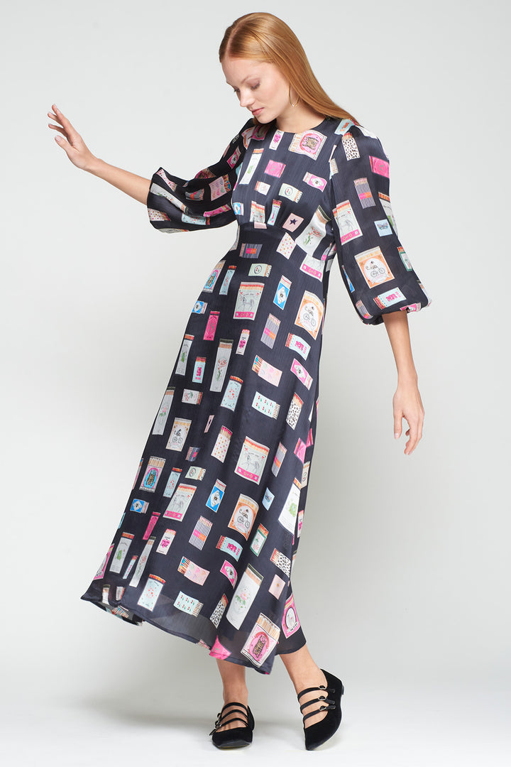 Woman wearing a patterned dress on a white background