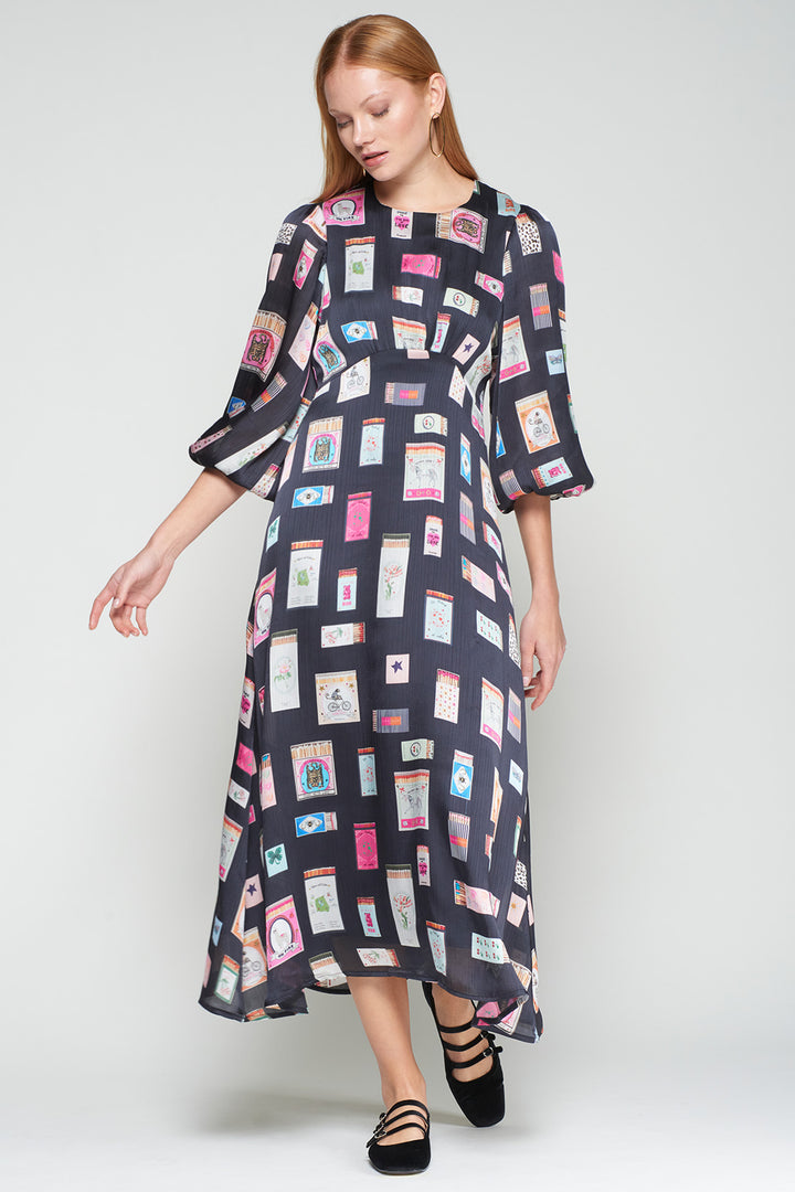 Woman wearing a patterned dress on a white background