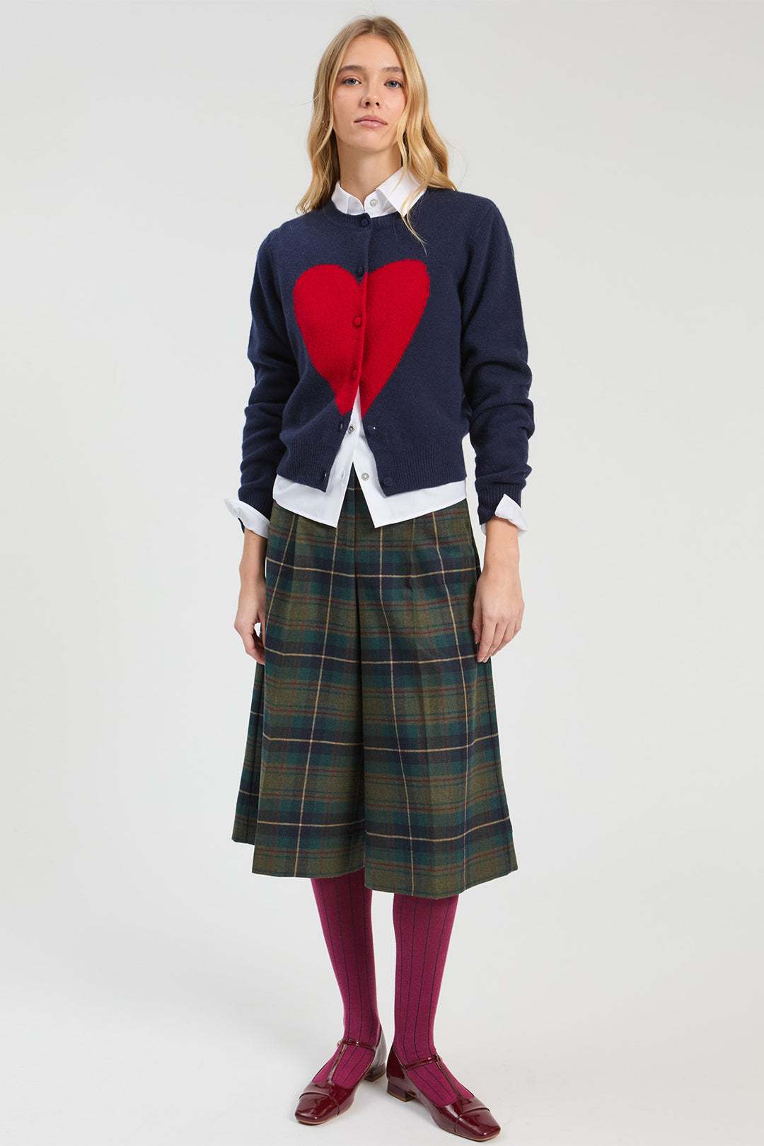 Vilagallo Navy & Red Hearts Jumper, front view styled with tartan skirt